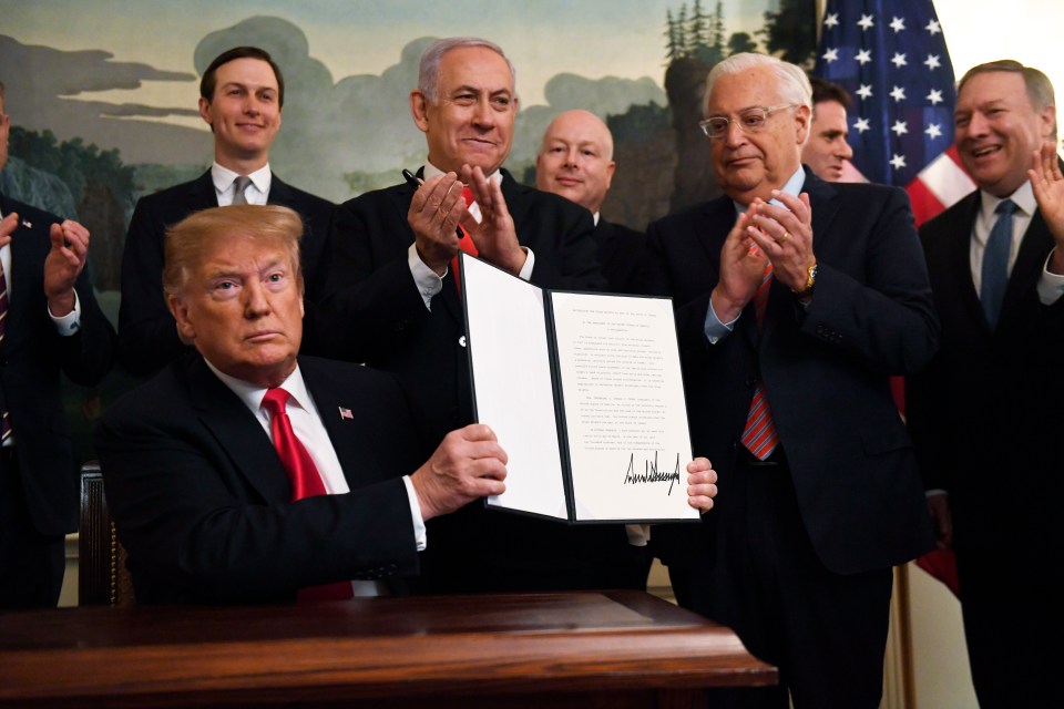  Donald Trump holds up a signed proclamation recognising Israel's sovereignty over Golan Heights, as Israeli PM Benjamin Netanyahu looks on in the White House, Washington, Monday, March 25