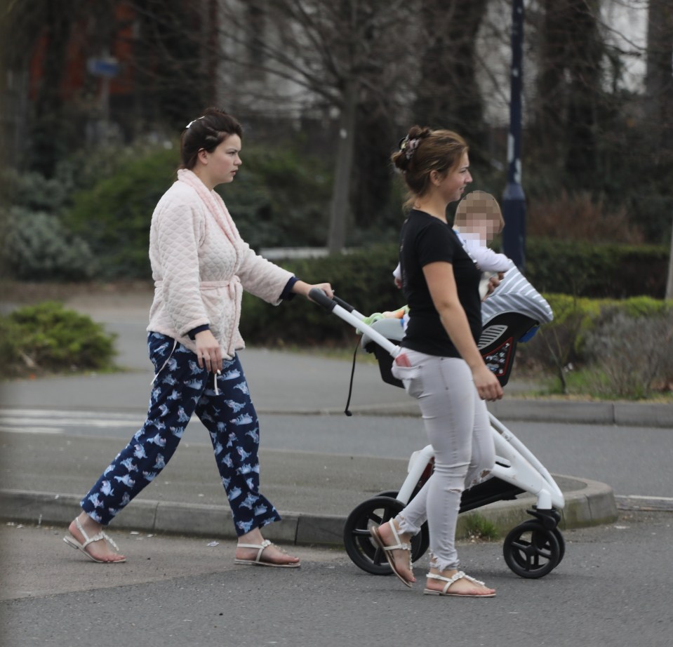  They appeared in pyjamas and smoking as they pushed children around the car park