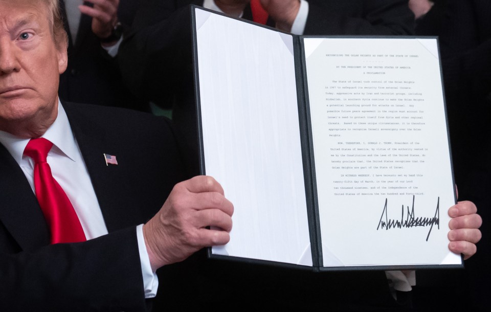  President Donald Trump holds up the signed proclamation