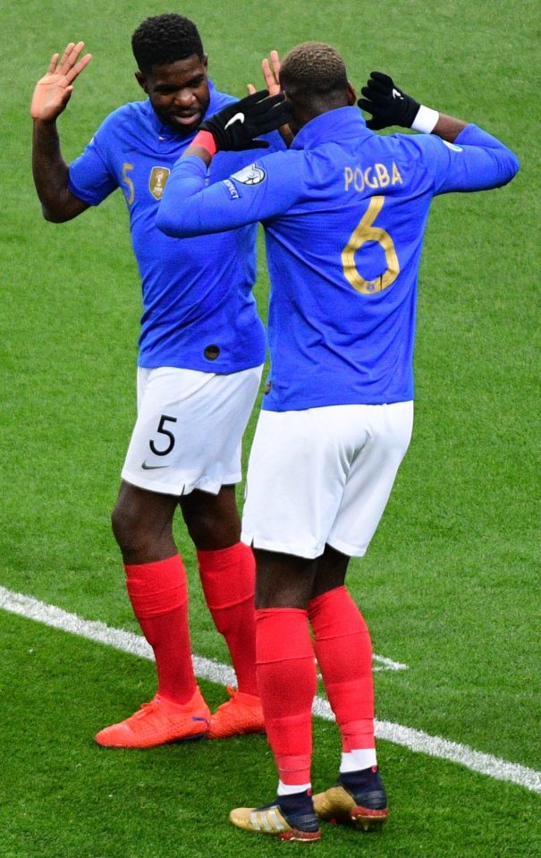  Paul Pogba helps Samuel Umtiti celebrate his early opener for France in Paris