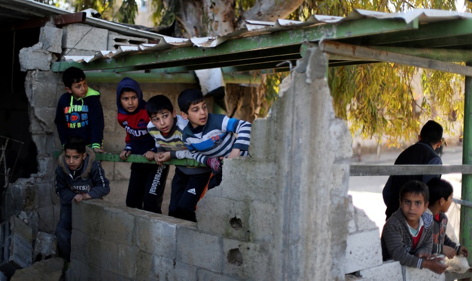  Palestinian boys at the site of one of the targeted buildings