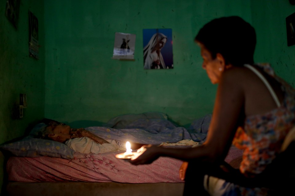  Ninoska Blanco sits beside her sick mother Alexandrian Blanco at her home