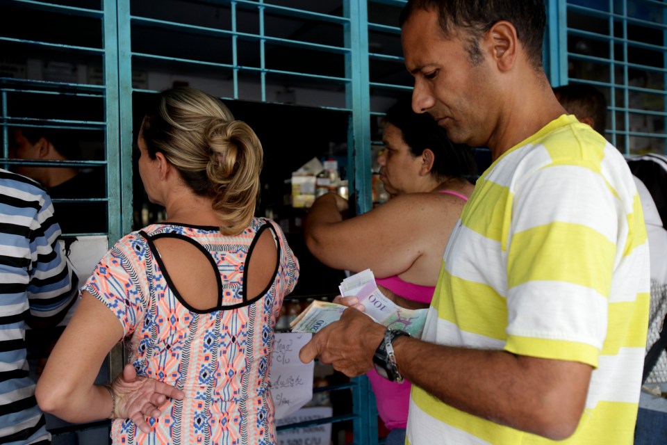  People queue to buy essentials which are in short supply