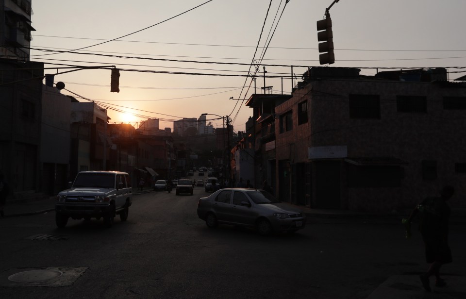  Vehicles move along a street without public lighting