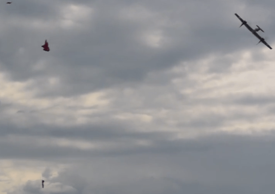  This image captures the moment the drone shoots the balloon - debris can be seen falling from the sky