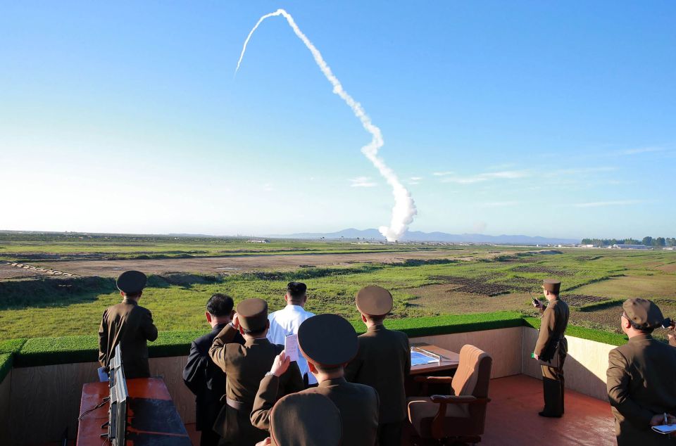  North Korean leader Kim Jong-un, wearing white, watching the test of a new anti-aircraft guided weapon system in May 2017