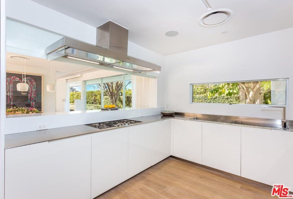  There's also a sleek white kitchen