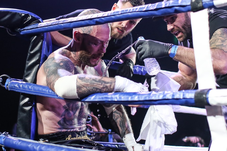  Chris Wheeldon takes a rest between rounds as his trainer shouts encouragement and pours water over him