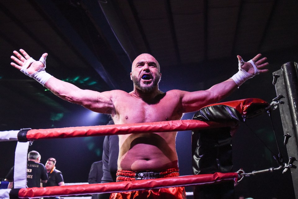  A boxer spreads his arms aloft as he celebrates victory