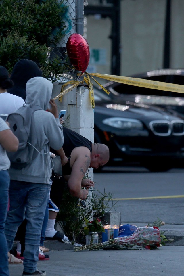  Fans leave flowers and light candles at a makeshift memorial for the rapper