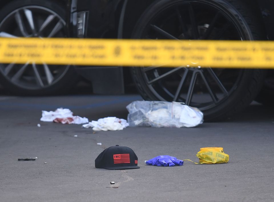  Blood stained bandages and bullet casing on the ground outside The Marathon clothing store in LA