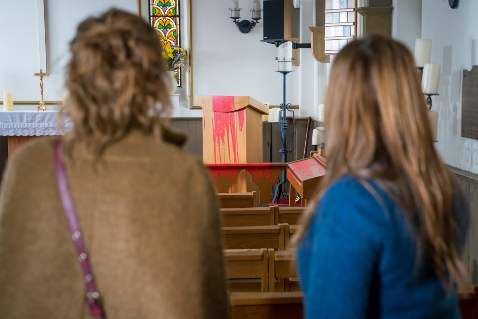  She is shocked when she discovers red paint all over the pulpit