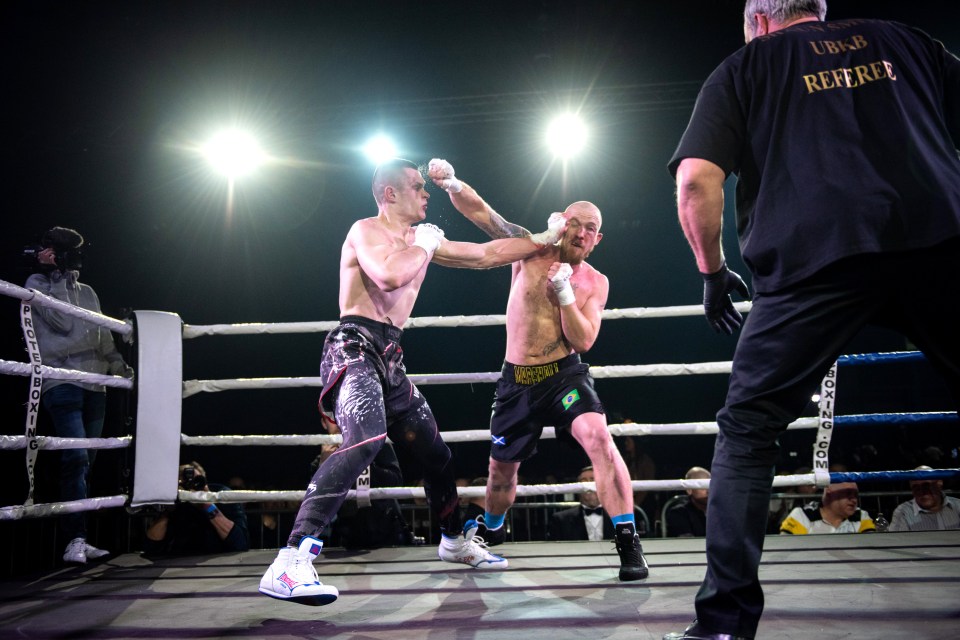  Lucas Marshall and Tadas Ruzga battle it out in the ring in front of a packed crowd