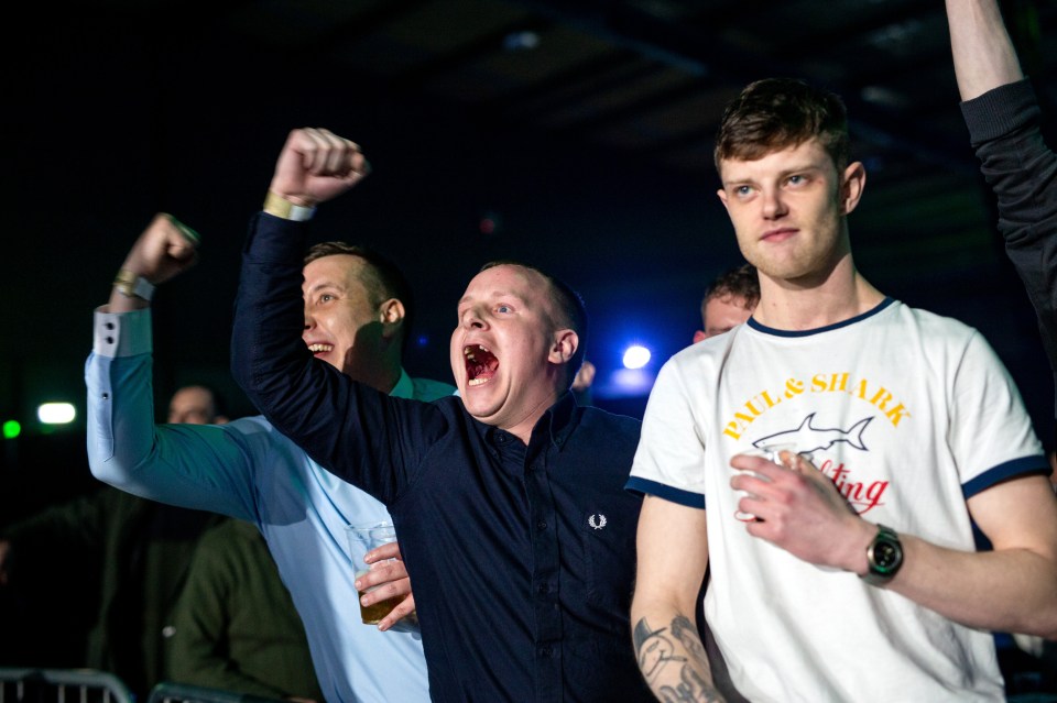  Ringside fans punch the air as they cheer on their heroes