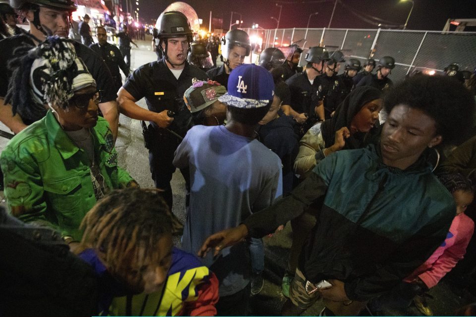  Police force crowds away after the mayhem last night