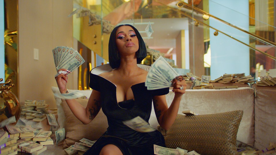  Cardi B showers herself with cash for a Palms Casino Resort advert