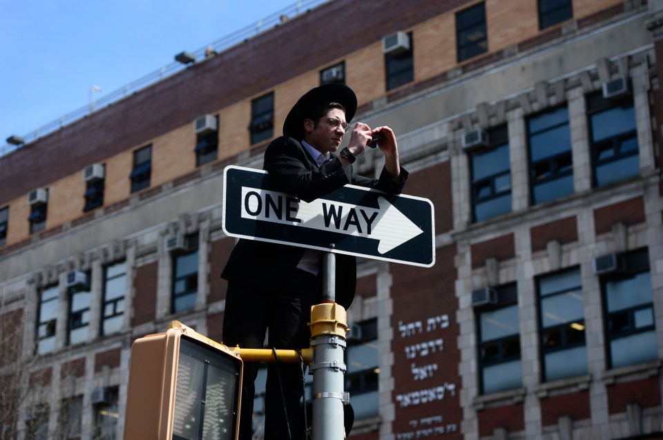  A boy climbed a signpost to take a snap - but not with a phone