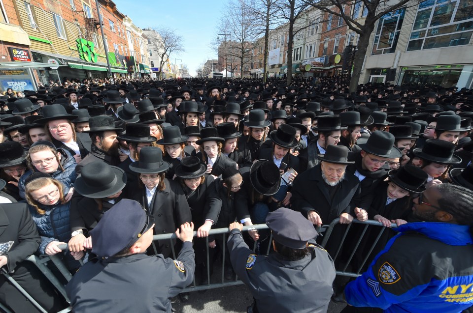  Mourners surged against barriers to get closer