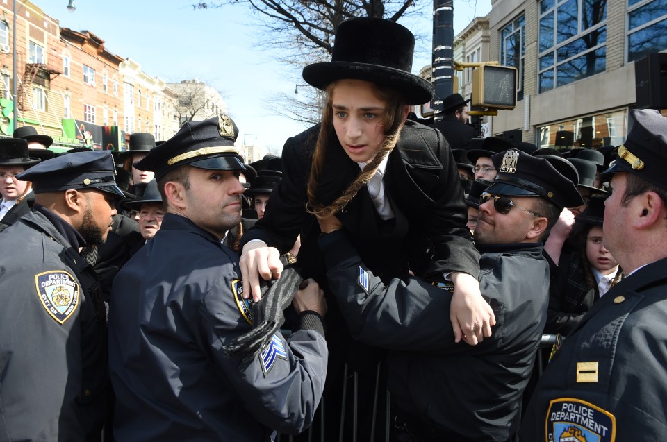  Police help a young man stuck in the crowd