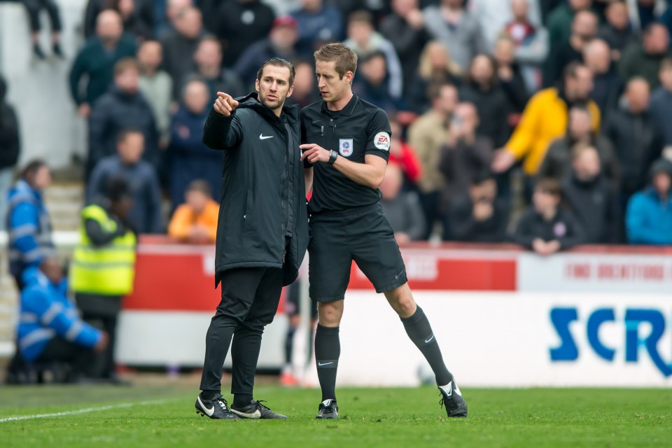  Match officials discuss the incident after a complaint was made