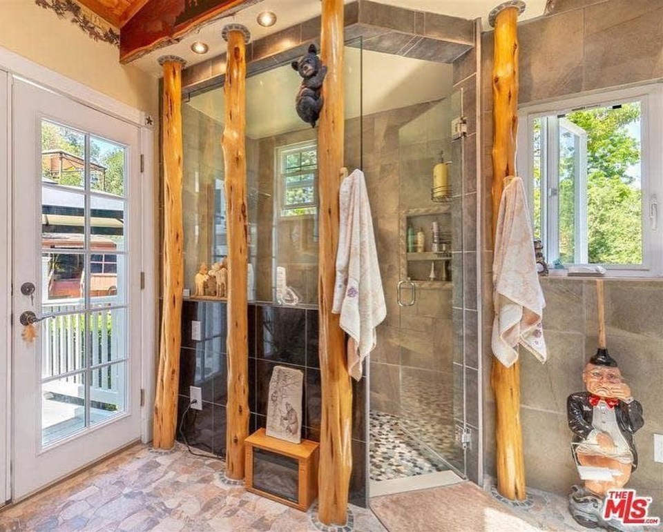  The wooded columns, fake bear and gnome plunger make this shower a cacophony of disasters