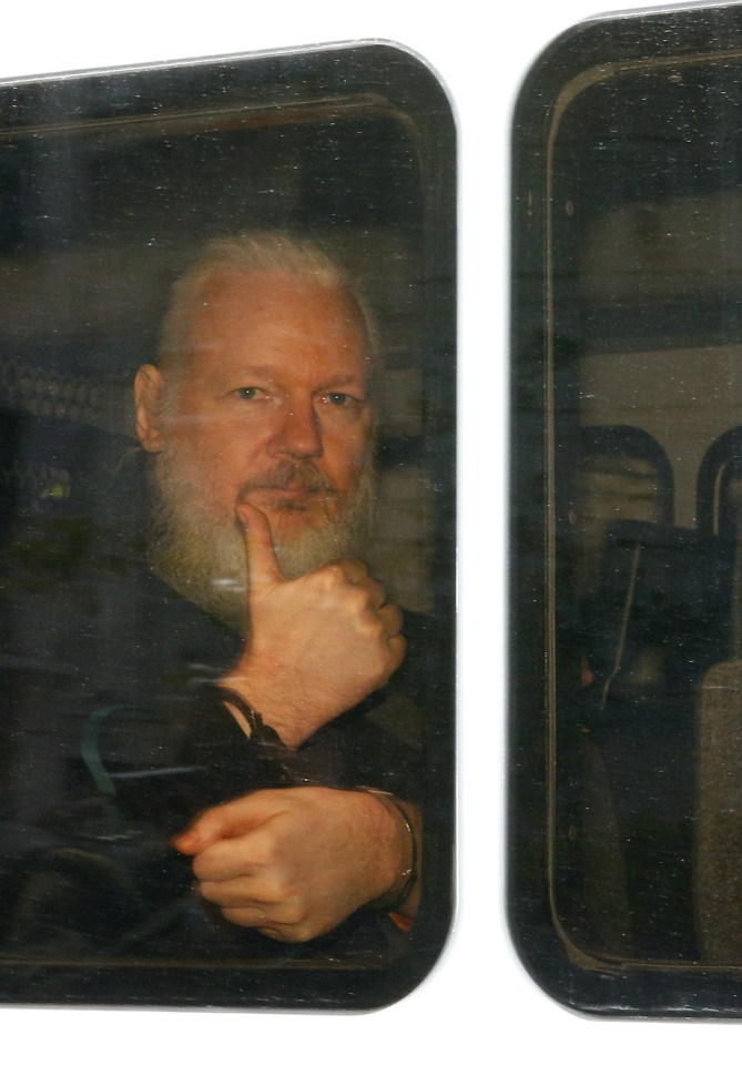  Julian Assange gave a thumbs up inside the police van after being dramatically arrested this morning