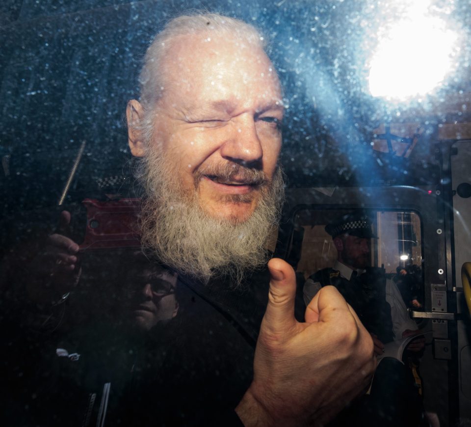  Julian Assange winked and gave a thumbs up from the police van as he arrived at court following the dramatic arrest this morning