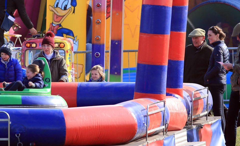  Stylish Kate keeps a watchful eye on Charlotte as she is on the carnival ride