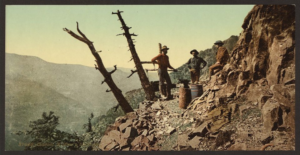 A blacksmith labours in the rugged landscape