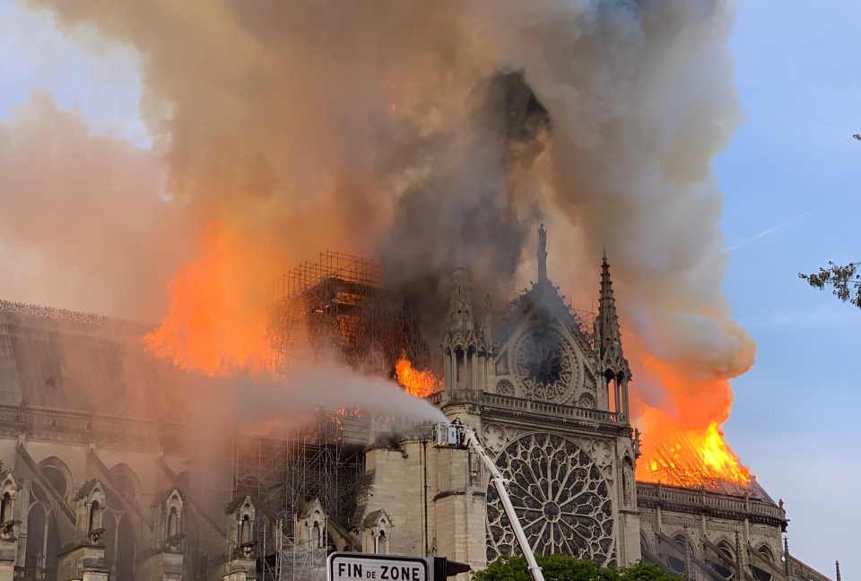  Firefighters douse the blaze with water in a bid to save the iconic building