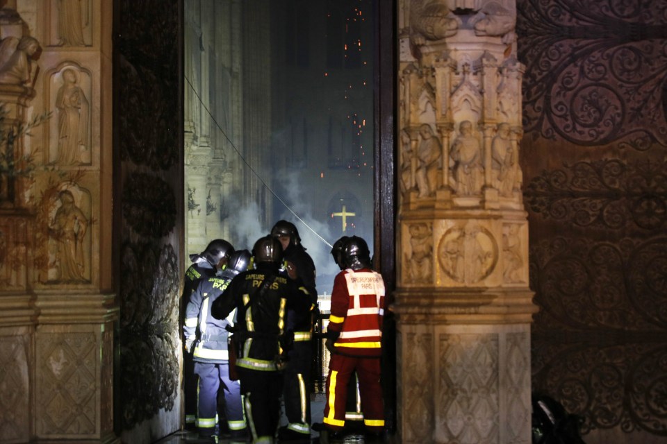  Firefighters enter the ancient building in Paris which contains priceless art work