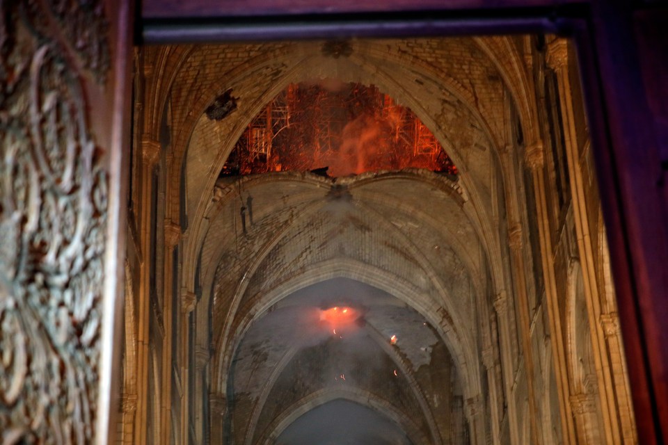 This photo shows the flames through damage in the Notre Dame's ceiling