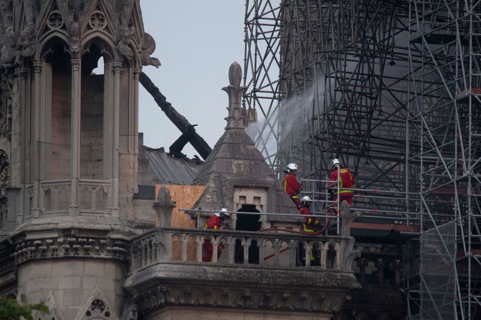  Firefighters are seen at the cathedral in the early hours of this morning