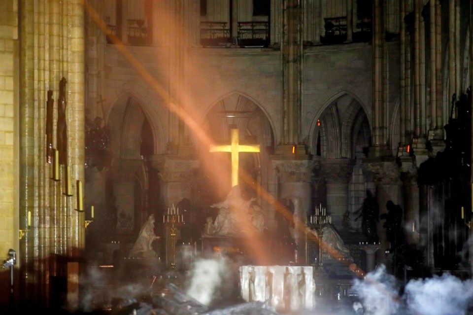  A haunting image shows the gold cross illuminated amid the wreckage