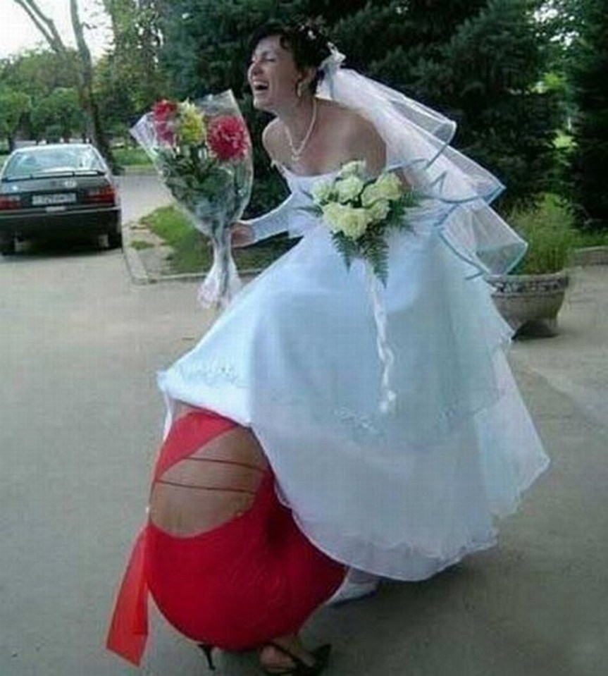  We can only guess what that bridesmaid is doing under there