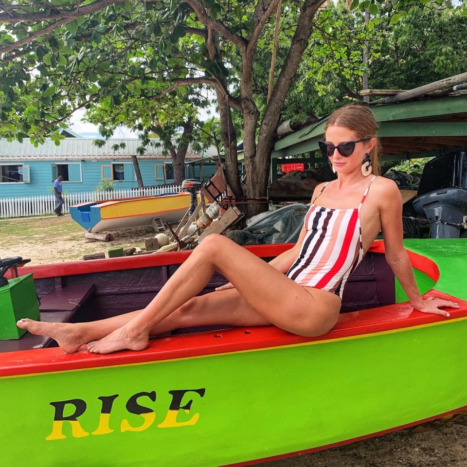  Millie soaks up the sun on holiday in striped swimsuit