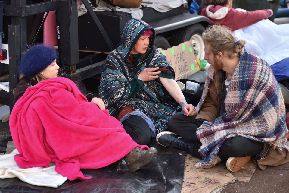  Protesters sit together at Oxford Circus, despite an order telling them to move to Marble Arch