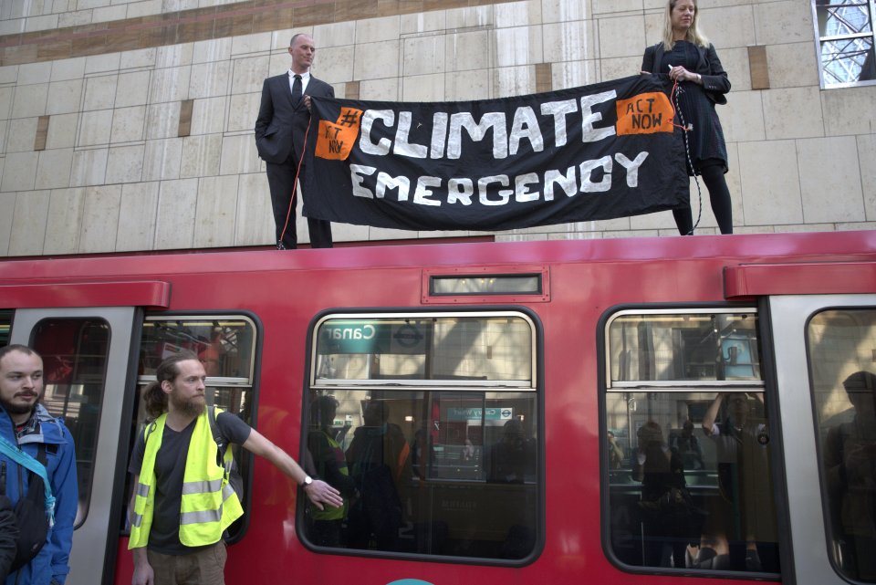  Activists yesterday caused minor delays after clambering on top of a DLR train