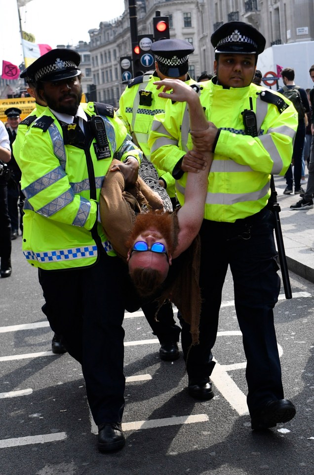  Protesters from the Extinction Rebellion campaign group are carried away as they block Oxford Circus yesterday