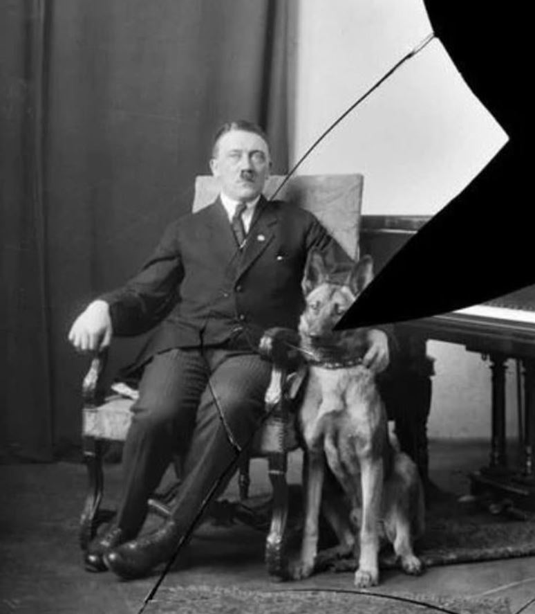  A cracked photo of the then 34-year-old Adolf Hitler flanked by his Alsatian, Prinz