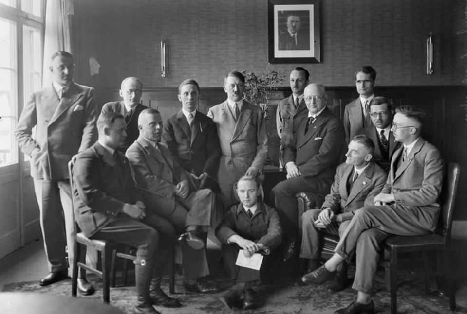  Hitler surrounded by members of the Third Reich, including his notorious minister of propaganda, Joseph Goebbels (stood to Hitler's right), as well as Rudolf Hess (standing in the top row on the far right), as well as Heinrich Himmler, the chief architect of the Holocaust (right)