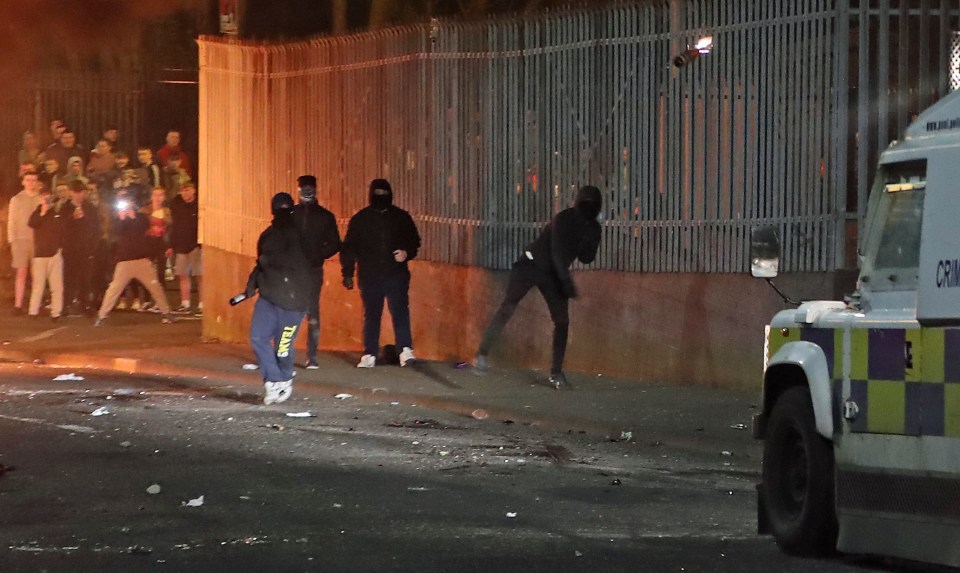 Masked men launched petrol bombs, bottles and missiles at police during rioting in Londonderry last night