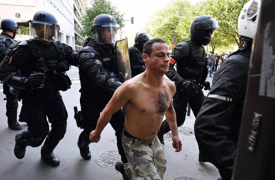  Police officers move along a yellow vest demonstrator in the Bercy neighbourhood of Paris