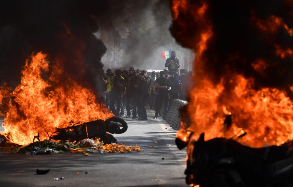  Protesters burning trash bins and motorcyles on the streets of Paris