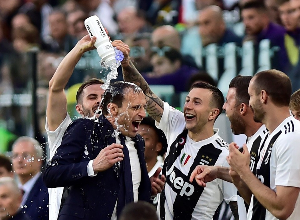  Juventus' players celebrate their title win by pouring champagne over Massimiliano Allegri's head