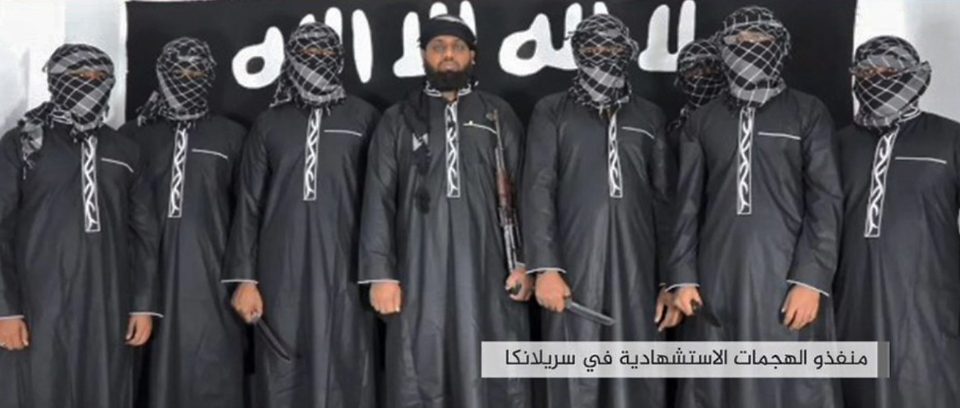  The Sri Lankan bombers pose in front of an ISIS flag before their attack