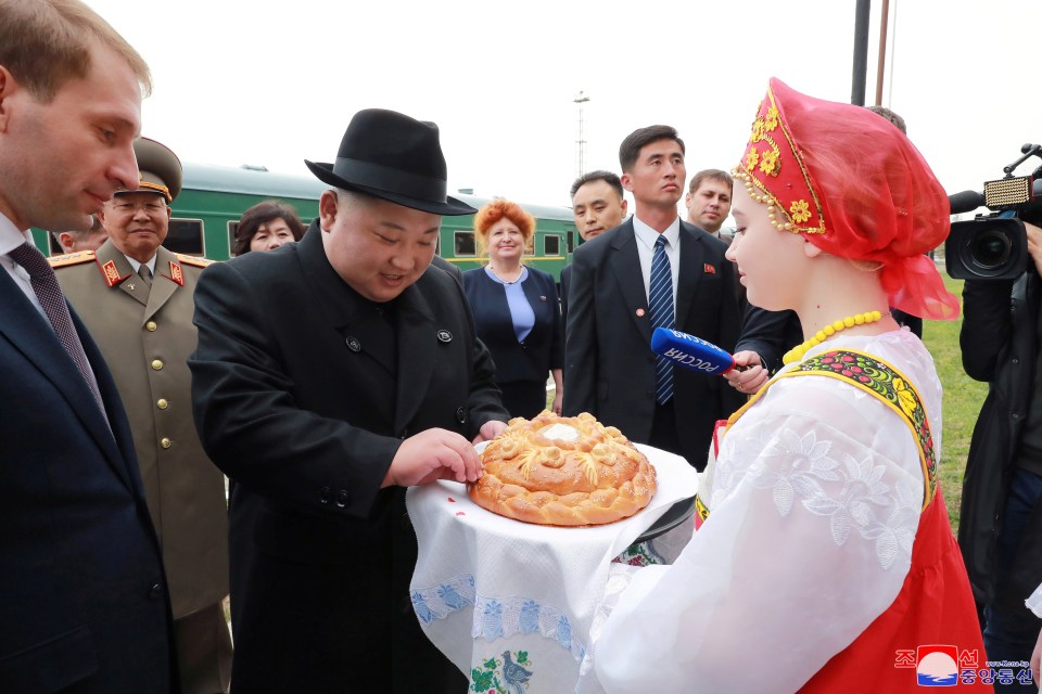  Kim takes part in a welcoming ceremony at a railway station in Khasan,