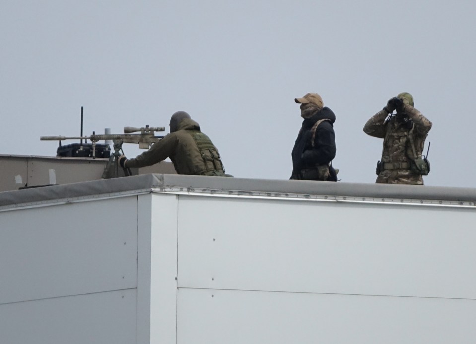  Snipers are deployed on the roof of the Sports Center at the university