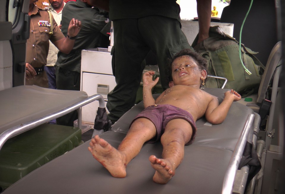  The youngster pictured lying on as stretcher in the back of an ambulance