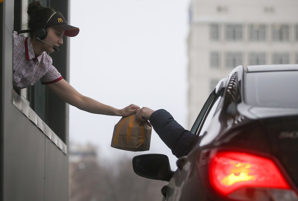 Drivers using a mobile phone to pay at a McDonald’s drive-thru can now be fined £200